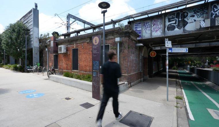 An adult male walking into Macdonaldtown Station