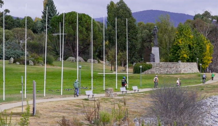 A group of people riding their bikes along Jindabyne Foreshore