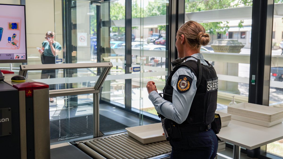 Sheriff's Officer at the scanners in Orange Courthouse.