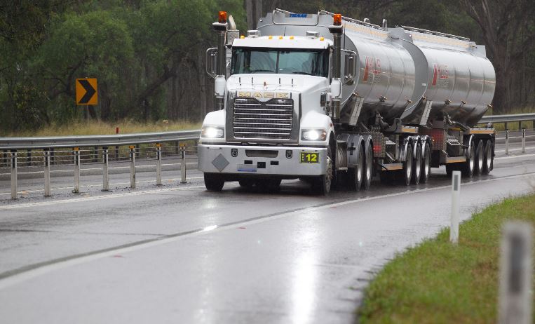 A freight truck driving down a highway