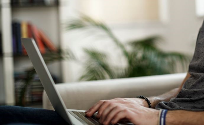 A man typing on a laptop