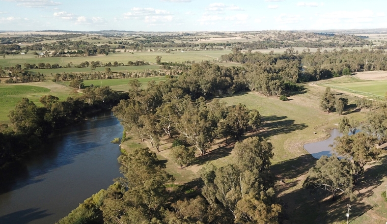 A creek going through rural land in NSW