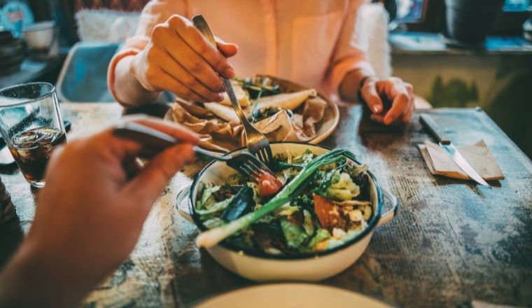 Two people sharing a meal inside a restaurant