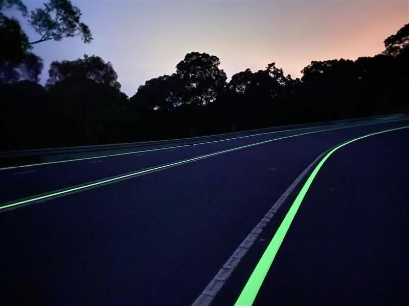 A road with lines and marking that glow in the dark