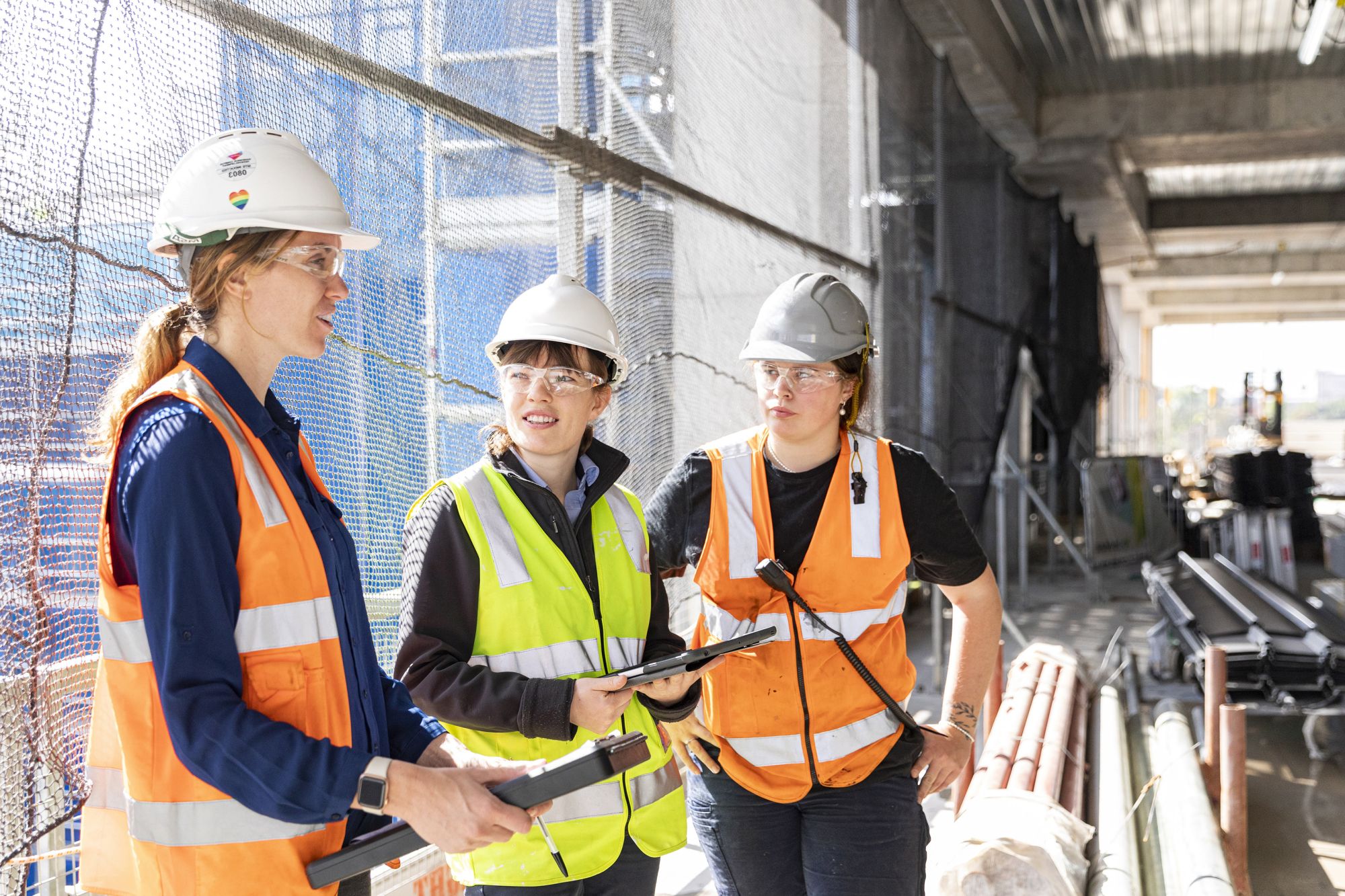 Jessica, Alice and a colleague are talking together on a construction site