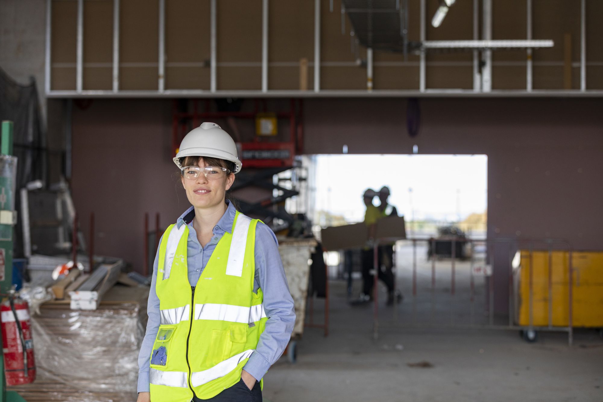 Alice is standing on a construction site.