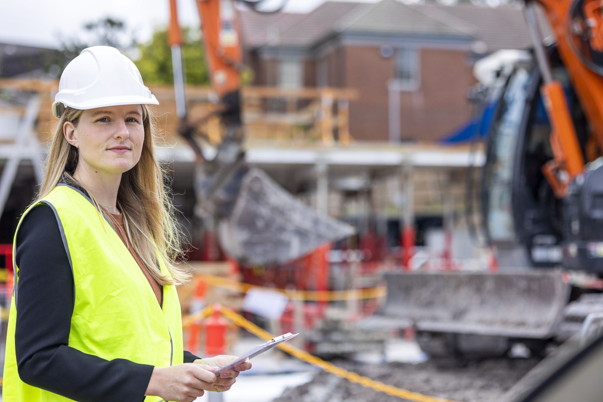 Stephanie is standing on a construction site.