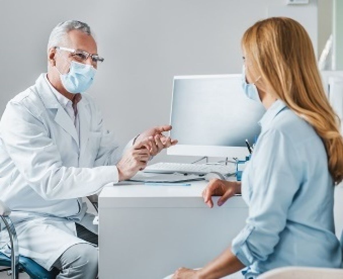 A doctor talking to a woman.