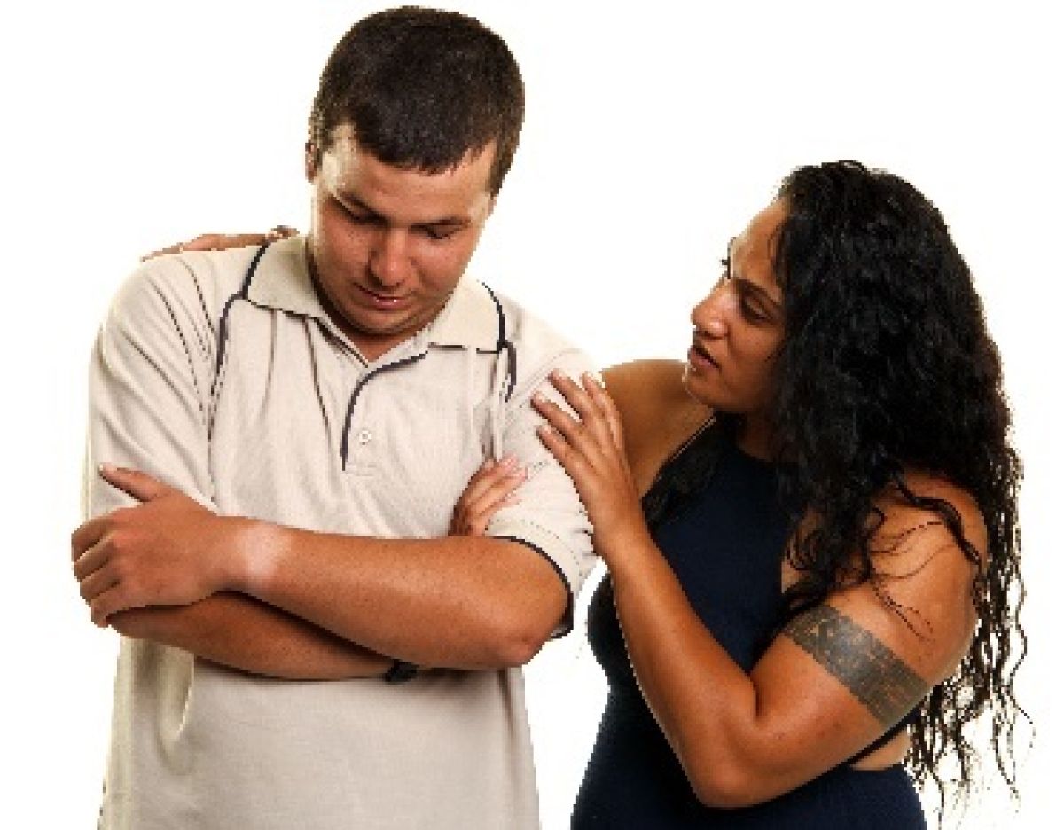 man hugging himself and being comforted by a female