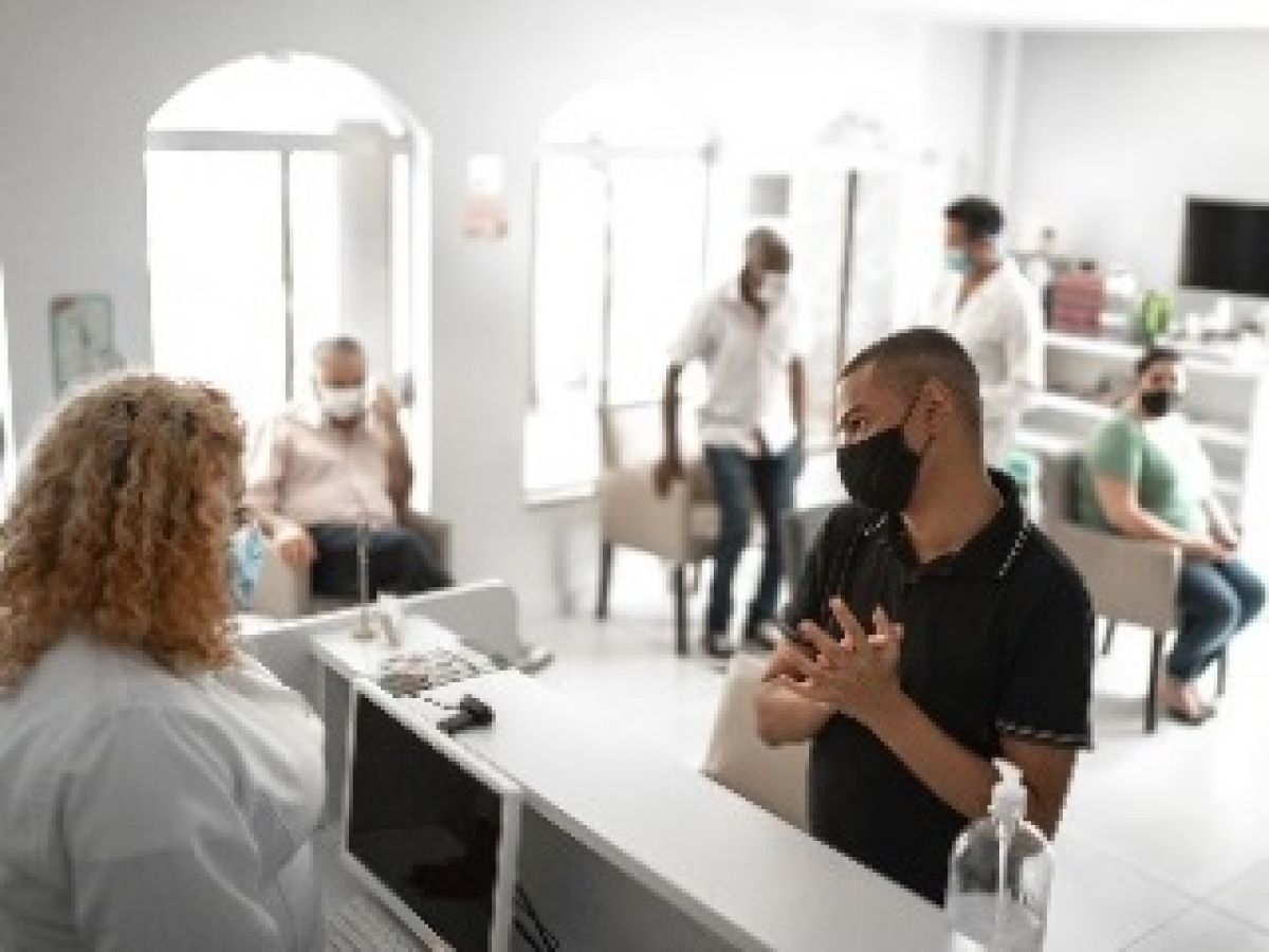 man standing at hospital reception