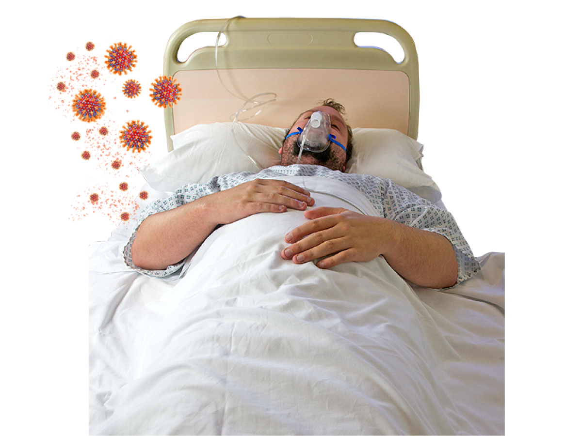 man wearing oxygen mask in hospital bed