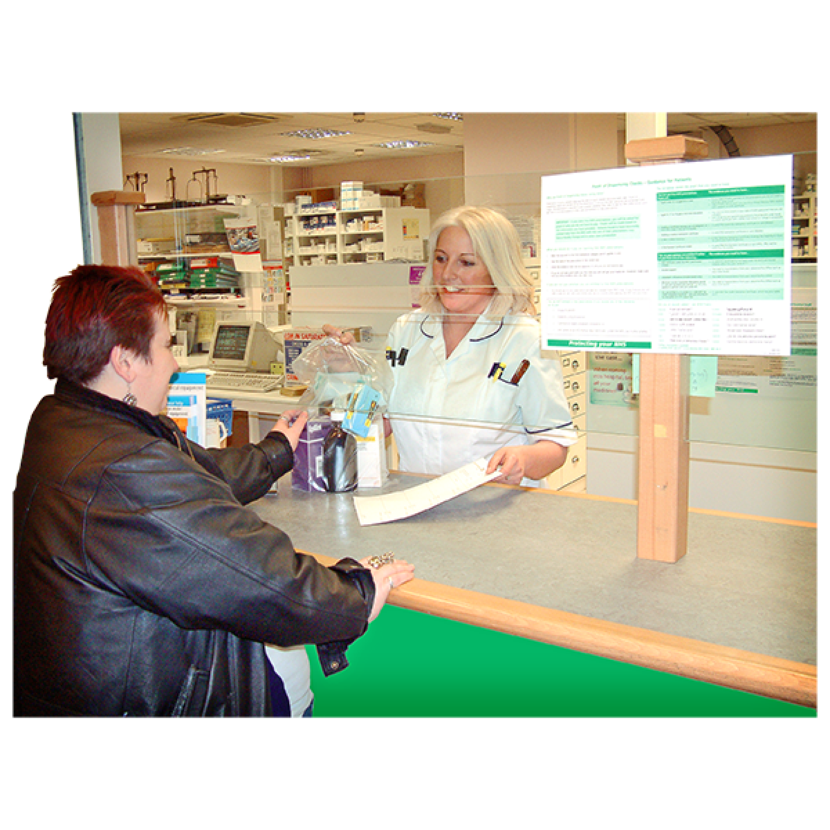 woman at pharmacy counter speaking with pharmacist