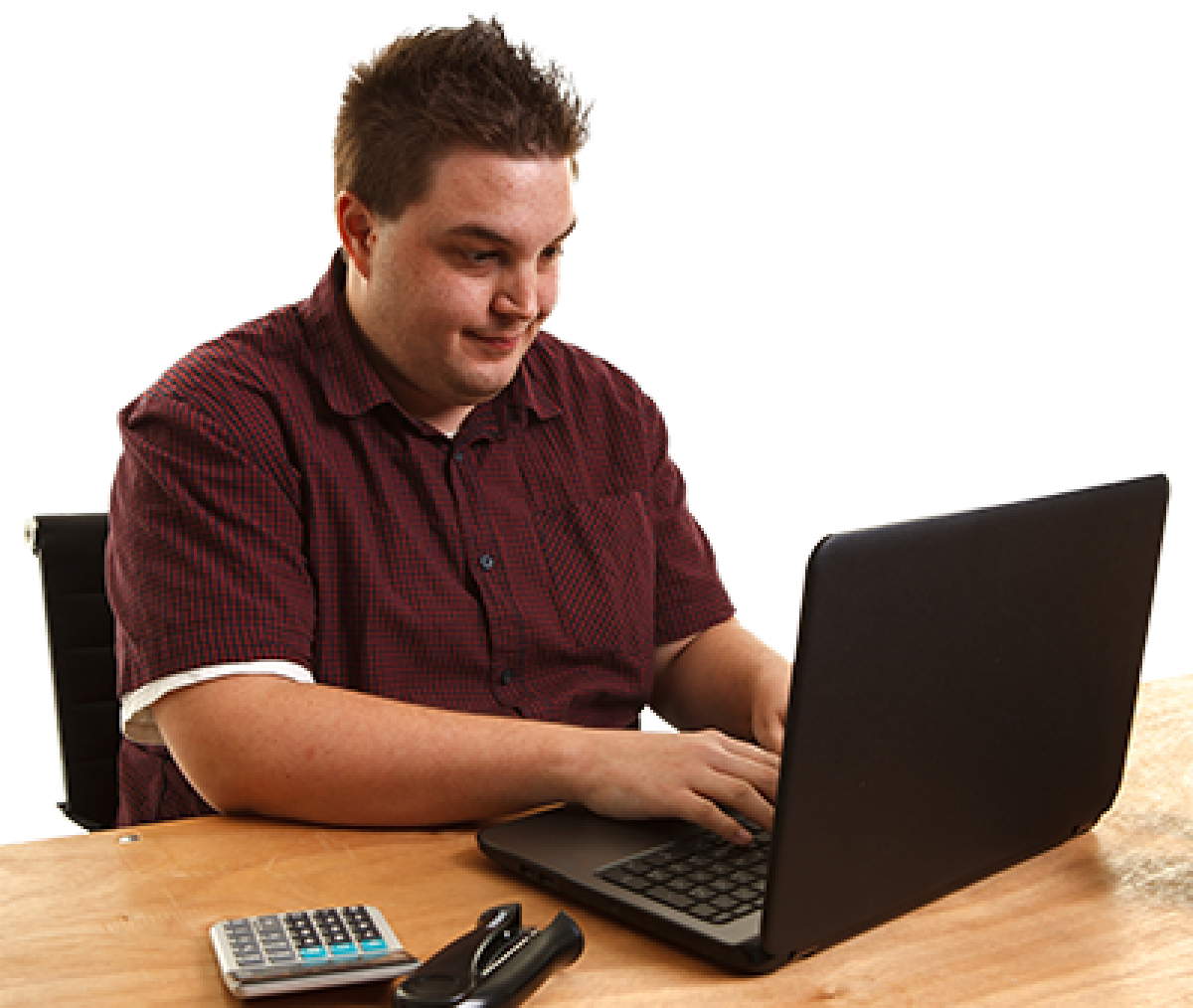 A person sitting at a desk in front of a laptop.