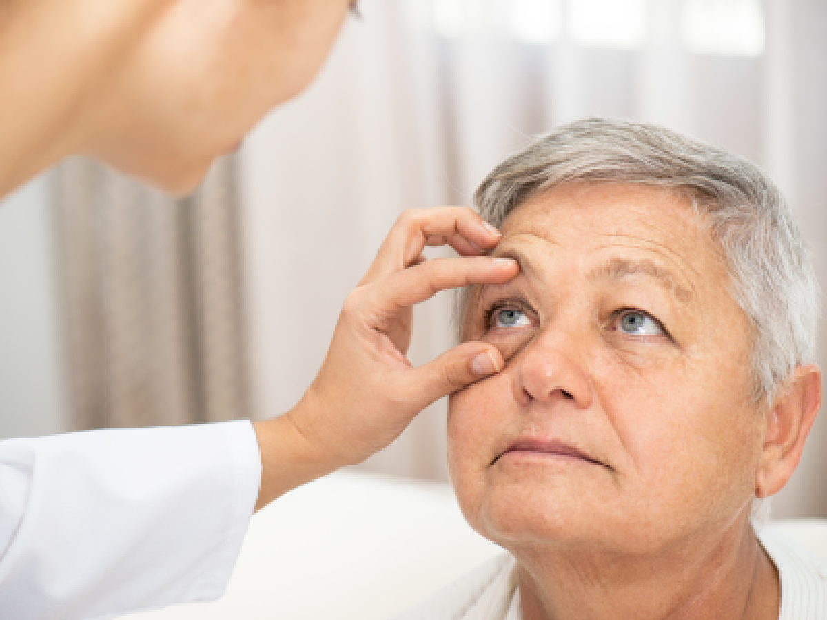 Doctor is looking at patients eye