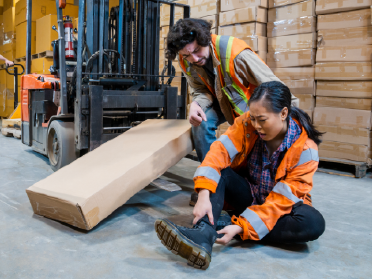 Women fallen over in warehouse with sore leg