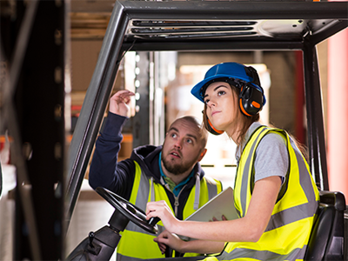 Women using machine wearing PPE