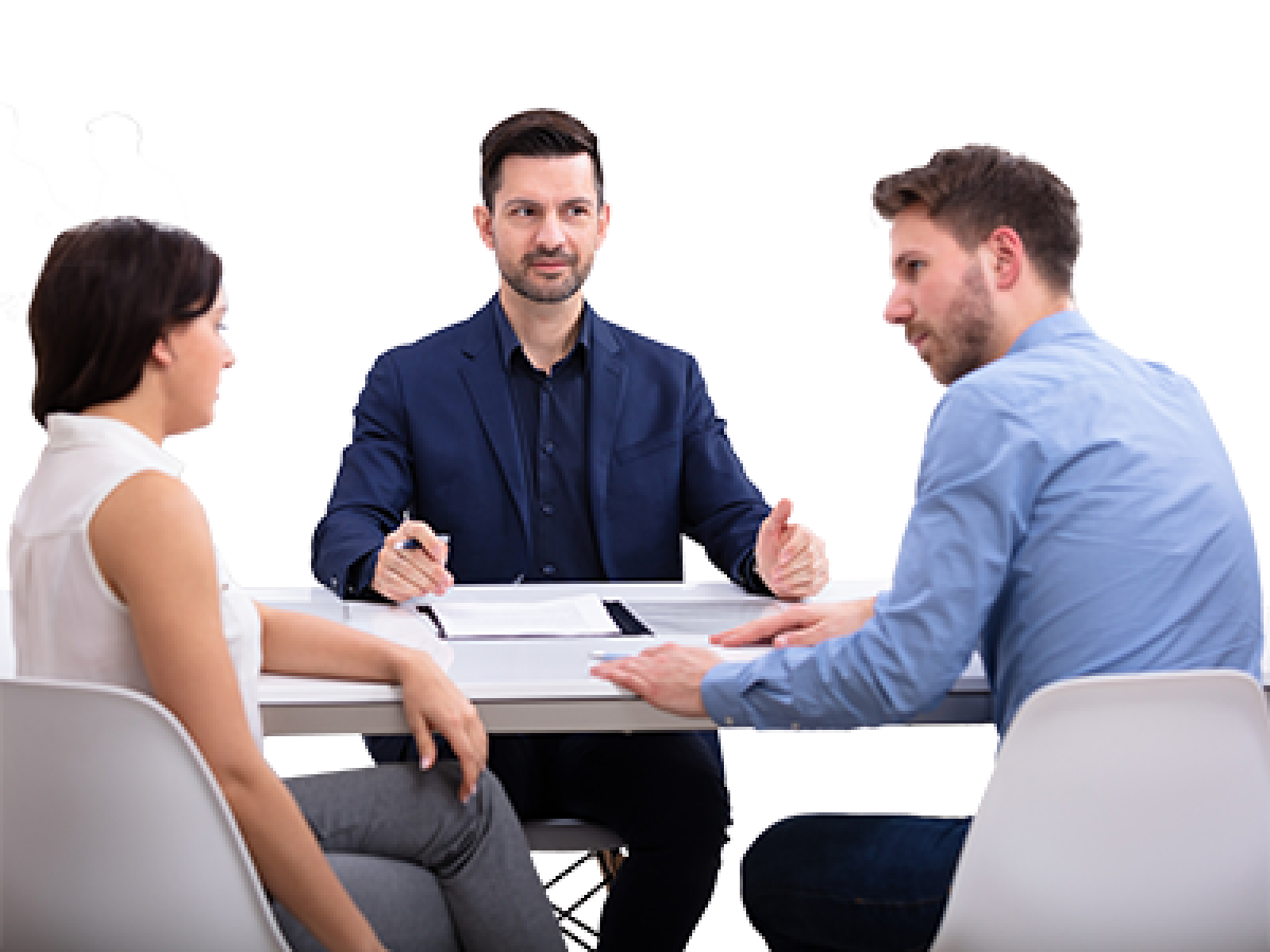 A mediator sitting at a table with 2 clients who are having a discussion.