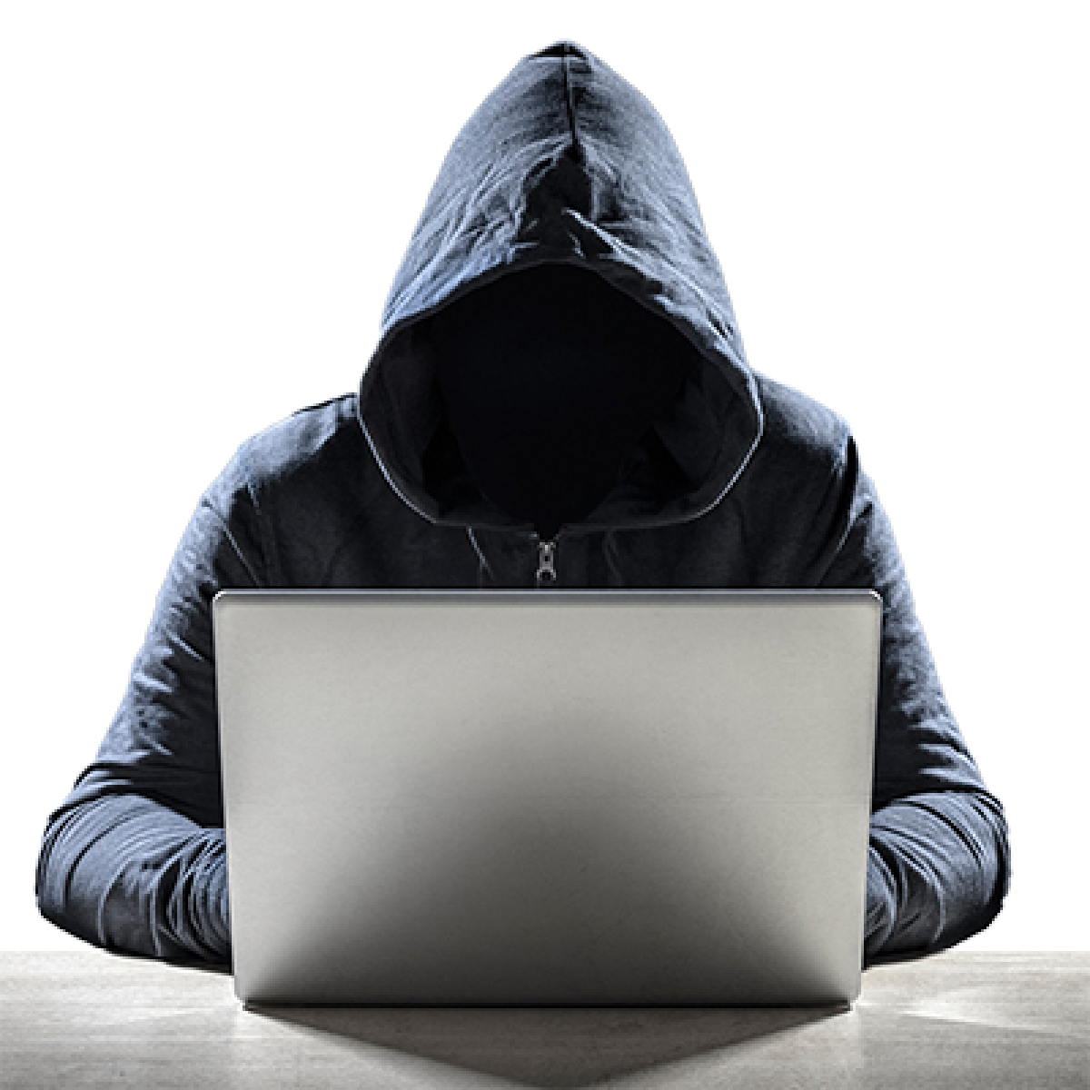 A person whose face is covered by a dark hoody using a laptop.