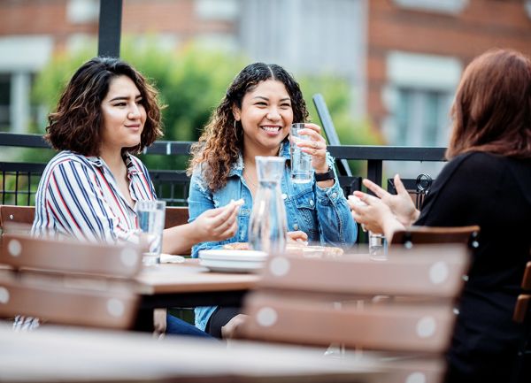 Group of three girlfriends enjoying lunch