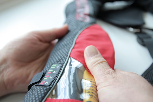 Lifejacket user checking fastenings are working