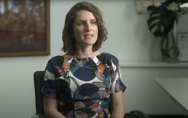 Woman sitting in chair talking about success stories