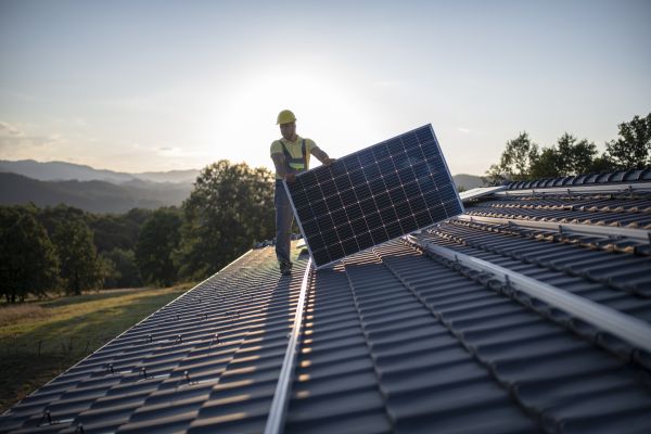 Solar panel installer on roof