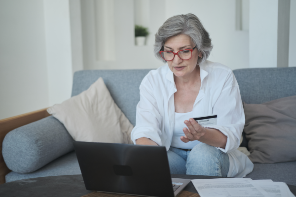 Older woman using a credit card to pay online