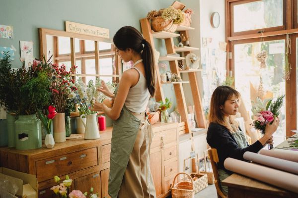 Young lady in a florist's shop working on an arrangement