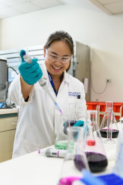 Woman working in a lab wearing PPE