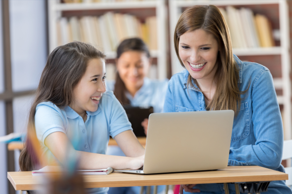 Student and teacher using computer