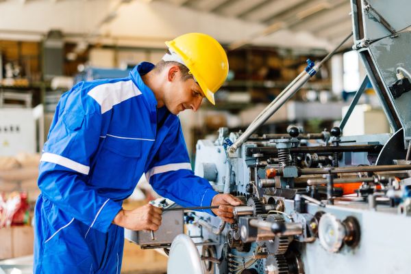 Male worker working on a car manufacturing assembly line