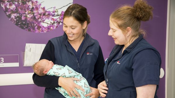 A midwife holding a baby