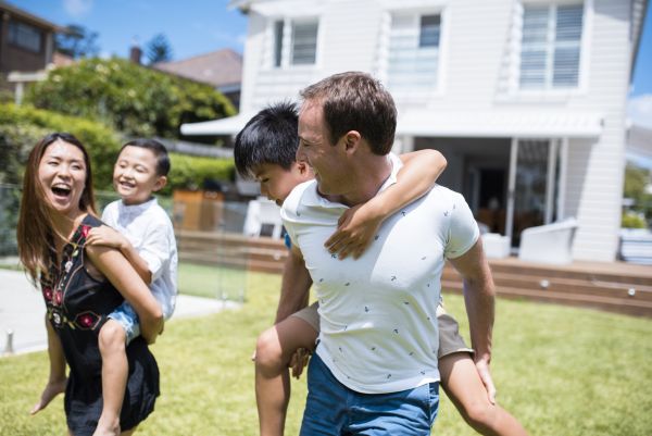 A young family playing in their backyard