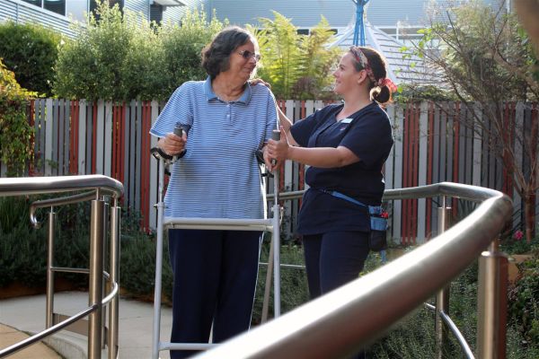 Allied Health professional providing physiotherapy to an older patient