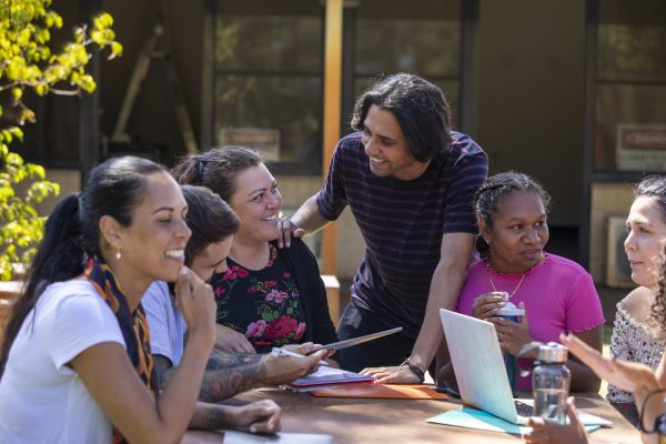 Image of a group of indigenous Australian people talking in a meeting