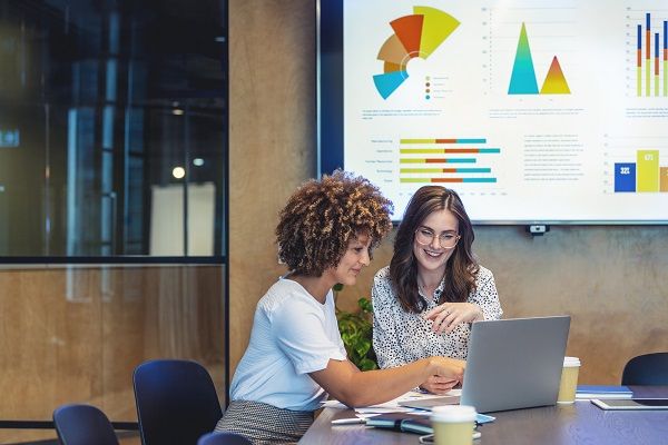 Two women looking at a laptop