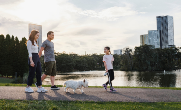 Young family walking past a river