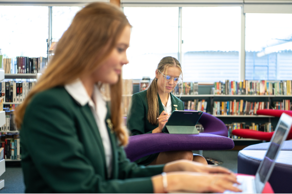 Two HSC students on laptops in a school library