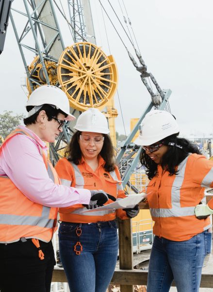 Three construction workers in high-vis at construction site