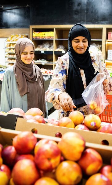 Two people at grocery store shopping