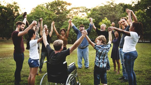 Group of people holding hand together in the park