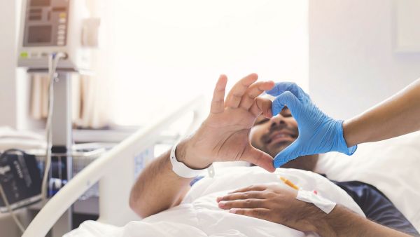 doctor and patient created a heart shape with hands.