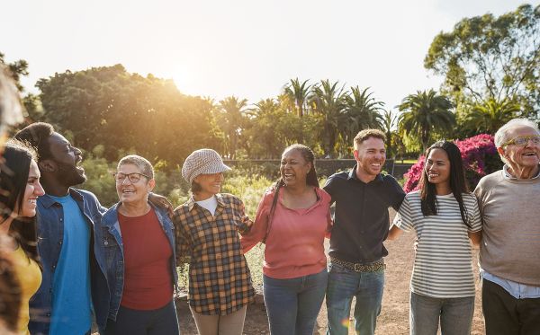 A group of culturally diverse people with arms around each other