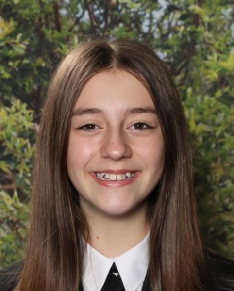 Photo of a teenage girl with long hair in her school uniform