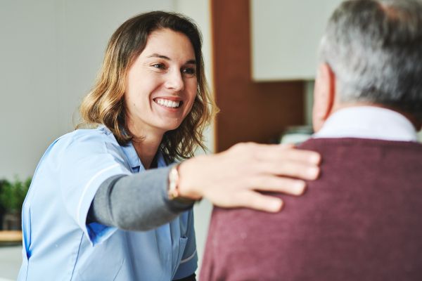 An aged care worker assisting a client