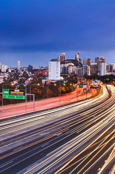 Traffic ribbon of lights weaves towards Sydney Harbour Bridge