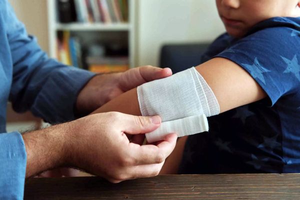 A child getting a bandage on their arm