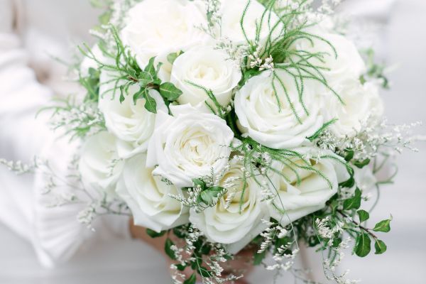 Image of bouquet of white flowers being held 