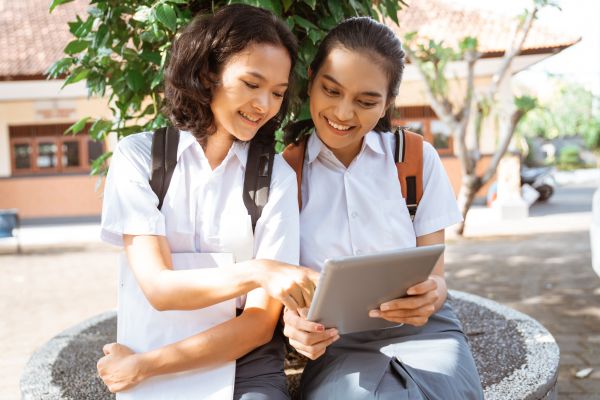 two girls on an ipad