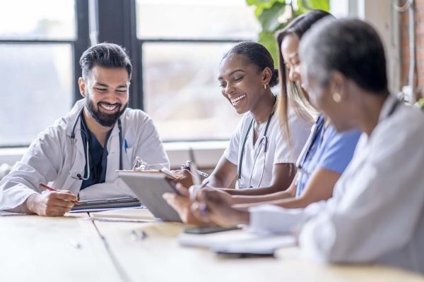 Group of medical workers sitting at table having a conversation. 